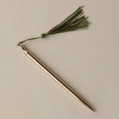 24k Gold Plated Ballpoint Pen by Roomytown, golden pen with a green tassel on a light background.