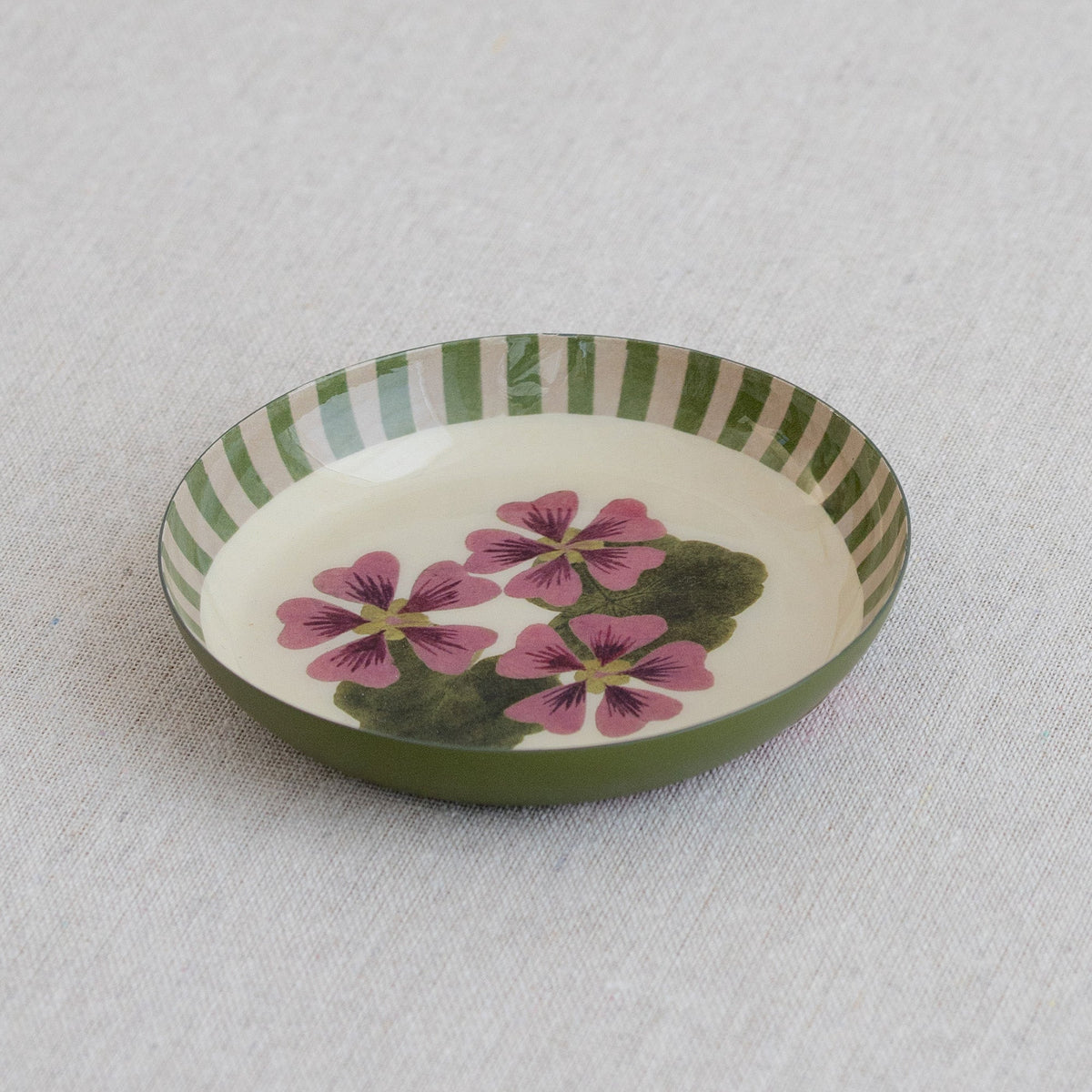 Roomytown Round Enamel Tray with pink floral design and green &amp; cream stripes on a light textured surface.