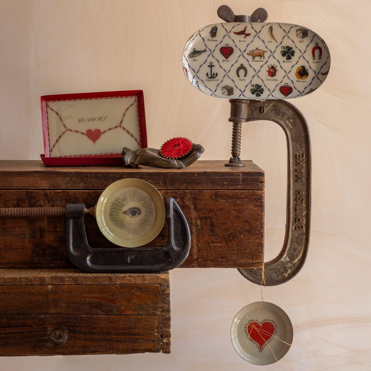 Roomytown Round Enamel Tray with French lucky symbols: Amour, Santé, Bonheur, Richesse, Coccinelle, and more, on a vintage setup.