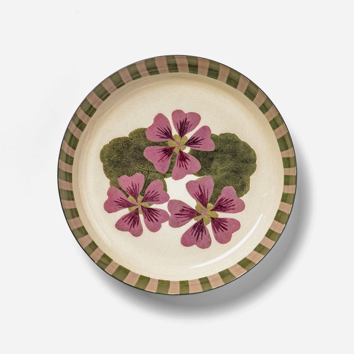 Roomytown Round Enamel Tray featuring a purple floral design with green leaves and a striped rim on a creamy background