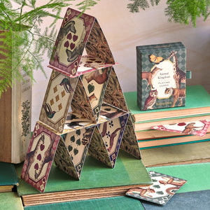 A house of cards built with Roomytown Animal Kingdom Single Deck Playing Cards, box visible in background.